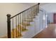 Interior shot of stairs with wooden treads and wrought iron railings at 5678 Kingsport Dr, Sandy Springs, GA 30342