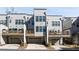 View of townhome featuring a two-car garage and an outdoor balcony at 2141 Burnside Nw Dr, Atlanta, GA 30318