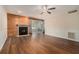 Bright living room features wood-look floors, fireplace, ceiling fan, and sliding doors to a porch at 28 Arbor End Se, Smyrna, GA 30080