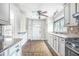 Traditional-style kitchen featuring white cabinets, stainless steel appliances, and tile flooring at 958 Winburn Dr, East Point, GA 30344