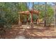 Cozy backyard pergola with stone pillars and a stepping stone walkway, ideal for outdoor gatherings at 1270 Seale Dr, Alpharetta, GA 30022