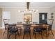 Elegant dining room with a long wooden table, decorative lighting, and stylish decor at 1270 Seale Dr, Alpharetta, GA 30022