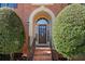 Inviting front door entrance with brick steps, iron railing, and manicured bushes at 1270 Seale Dr, Alpharetta, GA 30022