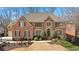 Brick home featuring an arched entryway and professionally landscaped front yard at 1270 Seale Dr, Alpharetta, GA 30022