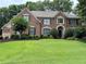 Beautiful brick home featuring a well-manicured lawn and mature trees at 1270 Seale Dr, Alpharetta, GA 30022