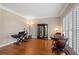 Bright living room with hardwood floors, a keyboard, decorative cabinet and elegant window shutters at 1270 Seale Dr, Alpharetta, GA 30022