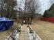 Brick pathway leads to a gazebo in a landscaped backyard with a covered pool on the side at 3038 Mary Alice Trl, Loganville, GA 30052