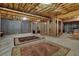 Unfinished basement featuring exposed ceiling with beams, concrete walls, and two large rugs at 777 Glen Valley Way, Dacula, GA 30019