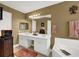 Clean bathroom with double sink vanity, soaking tub, and white cabinets at 777 Glen Valley Way, Dacula, GA 30019