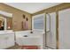 Bright bathroom featuring a corner soaking tub and separate glass shower at 777 Glen Valley Way, Dacula, GA 30019