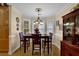 Dining room features a bay window, hardwood floors, neutral walls, and classic wood furniture for elegant meals at 777 Glen Valley Way, Dacula, GA 30019