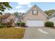 Charming brick home featuring a two-car garage, manicured lawn, and mature landscaping at 777 Glen Valley Way, Dacula, GA 30019