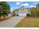 Brick home on a manicured lawn with driveway and mature trees at 777 Glen Valley Way, Dacula, GA 30019