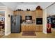 Kitchen featuring a center island, black stainless steel appliances, light wood cabinets, and hardwood floors at 777 Glen Valley Way, Dacula, GA 30019