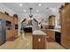 Bright kitchen featuring a kitchen island, natural cabinets, hardwood floors and views of the living room at 777 Glen Valley Way, Dacula, GA 30019