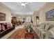 Bright and open living room featuring traditional furniture, neutral walls, decorative rug, and elegant lighting fixtures at 777 Glen Valley Way, Dacula, GA 30019