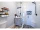 Bathroom featuring a vanity, glass-enclosed shower with dark fixtures, and unique floor tiles at 902 E Ponce De Leon Ave, Decatur, GA 30030