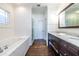 Elegant bathroom featuring double vanity, soaking tub, and separate glass shower at 902 E Ponce De Leon Ave, Decatur, GA 30030