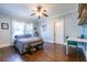 Bedroom features wood floors, a gray bed, lots of natural light, and a modern ceiling fan at 902 E Ponce De Leon Ave, Decatur, GA 30030