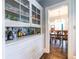 Hallway with hardwood floors, built in cabinet, and view to dining room at 902 E Ponce De Leon Ave, Decatur, GA 30030