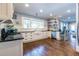 Spacious kitchen with white cabinets, dark countertops, hardwood floors, and open shelving at 902 E Ponce De Leon Ave, Decatur, GA 30030