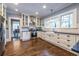 Modern kitchen with stainless steel appliances, white cabinetry, and hardwood floors at 902 E Ponce De Leon Ave, Decatur, GA 30030