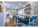 Stylish kitchen island with seating, black countertop, shelving, and eat-in space at 902 E Ponce De Leon Ave, Decatur, GA 30030