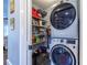 Efficient laundry space with stacked washer and dryer, shelving, and ample storage at 902 E Ponce De Leon Ave, Decatur, GA 30030