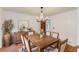 Dining room with rustic wood table, chandelier, and wainscoting at 2626 Delridge Dr, Lilburn, GA 30047