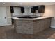 Basement bar with stone accents, granite countertops and wood cabinetry at 4401 Riverlake Way, Snellville, GA 30039