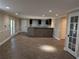 Open finished basement with tile floors, bar area, and access to the outdoors at 4401 Riverlake Way, Snellville, GA 30039