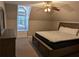 Cozy bedroom features a ceiling fan, natural light from a window, and neutral paint at 4401 Riverlake Way, Snellville, GA 30039