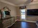 Large bedroom with hardwood floors, sizable window, and a decorative vanity at 4401 Riverlake Way, Snellville, GA 30039
