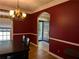 Formal dining room features elegant chandelier, trimwork, and beautiful hardwood floors at 4401 Riverlake Way, Snellville, GA 30039