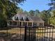 Charming single-Gathering home featuring a quaint porch and traditional architectural details at 4401 Riverlake Way, Snellville, GA 30039