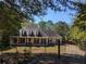 Charming home with a welcoming porch, manicured lawn, and wrought iron fence provides great curb appeal at 4401 Riverlake Way, Snellville, GA 30039