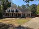 Traditional single-Gathering home featuring a quaint porch and driveway at 4401 Riverlake Way, Snellville, GA 30039