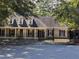 Traditional single-Gathering home with black wrought-iron fence and landscaped front yard at 4401 Riverlake Way, Snellville, GA 30039
