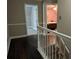 Upstairs hallway with hardwood floors leads to bedrooms and provides ample space at 4401 Riverlake Way, Snellville, GA 30039