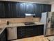 This kitchen boasts granite countertops and black cabinetry at 4401 Riverlake Way, Snellville, GA 30039