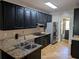 This kitchen boasts granite countertops and black cabinetry at 4401 Riverlake Way, Snellville, GA 30039