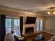 Cozy living room with fireplace and views of outdoor deck at 4401 Riverlake Way, Snellville, GA 30039