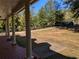 View from porch with white columns and a landscaped yard with a long driveway at 4401 Riverlake Way, Snellville, GA 30039