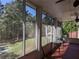 Screened porch with a view of the backyard, offering a tranquil outdoor living experience at 4401 Riverlake Way, Snellville, GA 30039