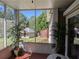 Relaxing screened porch with outdoor furniture, providing a serene and private view of backyard at 4401 Riverlake Way, Snellville, GA 30039