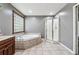 Spacious bathroom with separate shower and tub, and light tile floors at 5074 Pittman Rd, Cumming, GA 30040