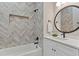 Modern bathroom with herring bone tile accent wall, soaking tub and quartz countertops at 660 Timm Valley Ne Rd, Atlanta, GA 30305