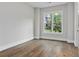 An empty bedroom features newly finished hardwood floors and a sunlit window at 660 Timm Valley Ne Rd, Atlanta, GA 30305