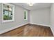 Bright and airy bedroom with hardwood floors, a neutral color scheme, and natural light from large windows at 660 Timm Valley Ne Rd, Atlanta, GA 30305
