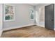 Bedroom with hardwood floors, large windows, and a gray painted ensuite bathroom door at 660 Timm Valley Ne Rd, Atlanta, GA 30305